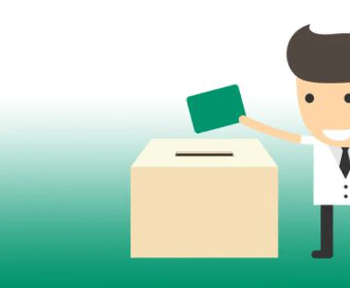 Figur wirft Stimmzettel in Wahlurne